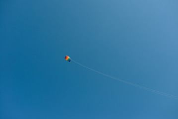 colorful rainbow kite in the blue sky
