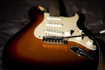 Fototapeta na wymiar 6 string electric guitar body with white pickguard, tremolo and bridge