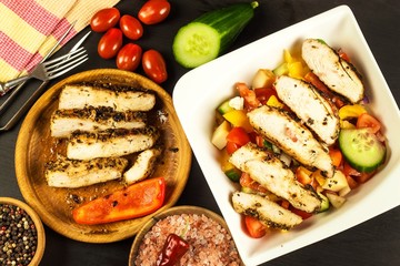 Chicken meat with vegetables. Chilli peppers marinade. Grilled food. Protein diet. Food for athletes.