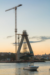 Obraz premium View of Construction of bridge with crane and boats in water