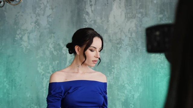 stylish sexy young girl model stands in a long blue dress