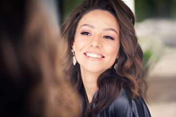 Fototapeta premium beautiful young woman with dark hair in the beauty salon before the show