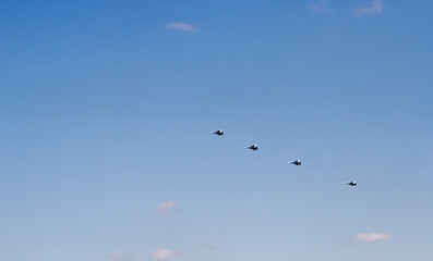 Military aircraft against the blue sky. Sunny day. Aircraft. Fighters