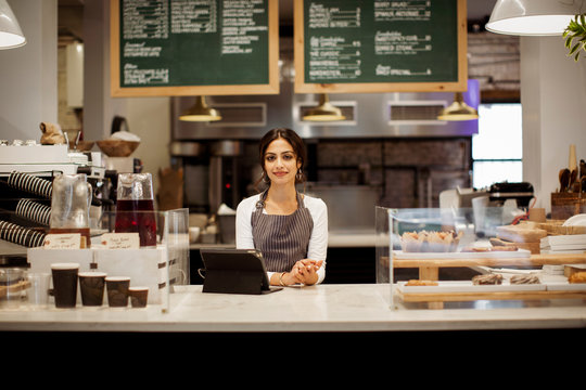 Portrait of owner standing in cafe