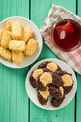 Sweet biscuits dessert and red fruity tea.