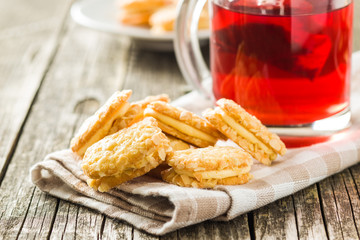 Sweet biscuits dessert and red fruity tea.