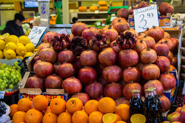 Pomegranate, oranges and lemons on the famous market of Riga, Latvia. Colorful fresh fruits on the market. Healthy food.