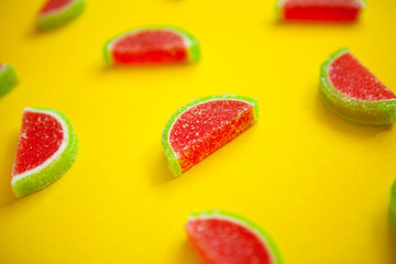 Fruit jelly segments in the form of watermelon on yellow