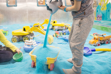Sandbox and toys. Blue sand. Kinetic sand. 