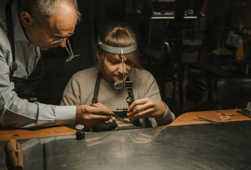 Artisan and his coworker making jewelry in his workshop