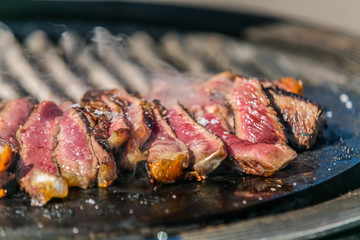 Fresh, delicious grilled meat. Grilling steak on BBQ. Close up view of grilling steak