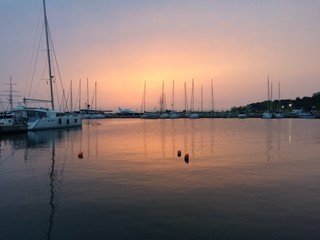 Fototapeta na wymiar Boats, marina at dawn, sunrise clouds,Thessaloniki Greece 