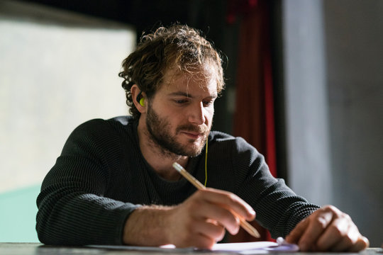 Portrait of man at theatre working on script