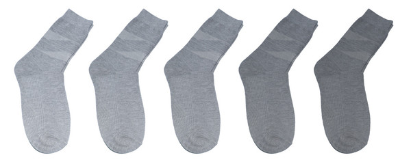 Grey socks of different colors. Socks in a row on a white background. Gray socks on a white background. From light to dark...