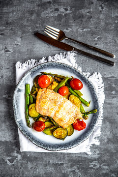Coalfish fillet on zucchini, green asparagus and tomato, low carb