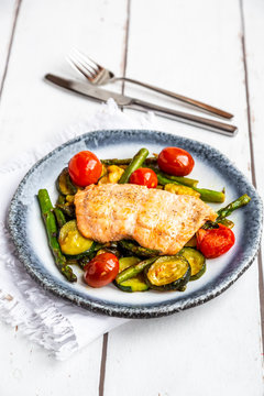 Coalfish fillet on zucchini, green asparagus and tomato, low carb
