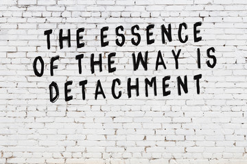 White brick wall with painted black motivational quote inscription