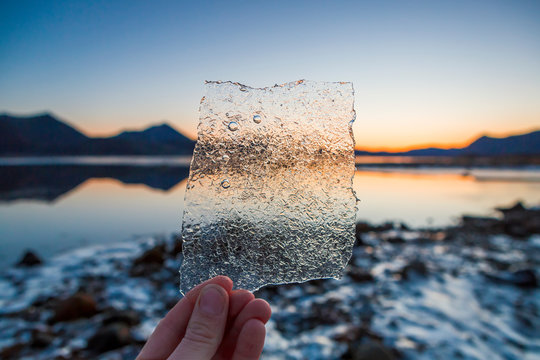 Norway, Lofoten Islands, man's hand holding thin ice