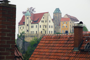 Obraz premium Old castle - fortress Hohnstein in Spring. Saxony, Germany. The castle nearby the village.