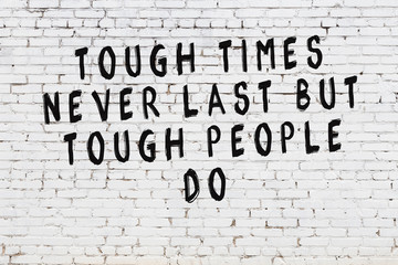 White brick wall with painted black motivational quote inscription