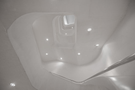 Interior view of illuminated white stairway