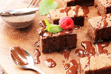chocolate brownie cake dessert with raspberry and spices on a rustic background