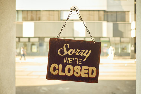 Close sign at small business window with blurred background