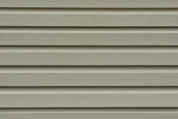 Obraz premium Element of the facade. Part of the facade decoration close-up. Facing material of buildings. Metal sheet roof. Horizontal sheet. Grey.