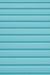 Obraz premium Element of the facade. Part of the facade decoration close-up. Facing material of buildings. Metal sheet roof. Horizontal sheet. Blue color.