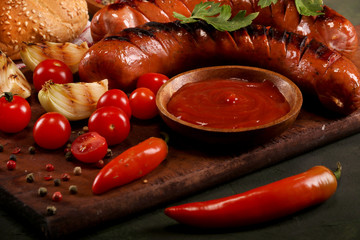 Grilled sausages with vegetables, spices and bread on wooden cutting board background