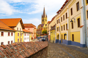 Street view of Lutheran Cathedral of Saint Mary (Catedrala Evanghelica C.A. Sfanta Maria) in Sibiu, Romania, a dramatic 14th-century church with a baroque organ, historical artifacts and lookout tower