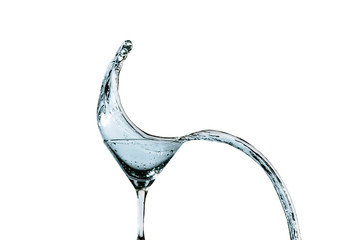 Beautiful splash of liquid from a martini glass on a white background.