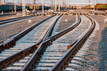 Obraz premium View of the rails, concrete sleepers and mound of crushed stone. The railroad tracks.