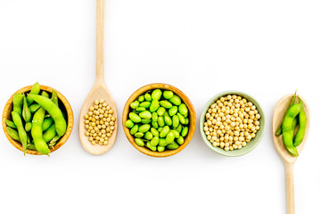 Edamame in bowl and spoon on white background top view