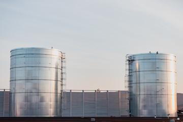 Huge tanks for storage of liquids are located near the railway.