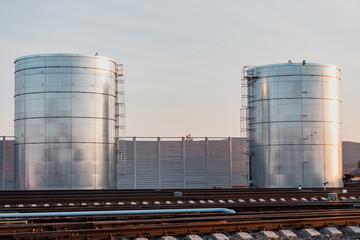 Huge tanks for storage of liquids are located near the railway.