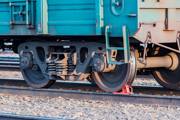 Railway carriage stands on the rails. Wagon wheels. Rails.