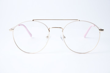 Round glasses for vision on a white background. Glasses with a gold metal frame.