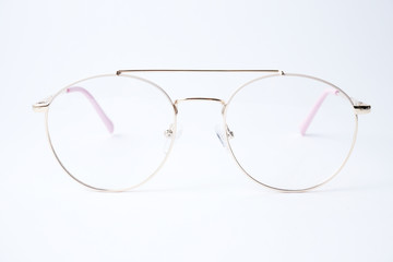 Fototapeta premium Round glasses for vision on a white background. Glasses with a gold metal frame.