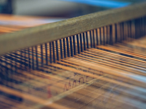 White and orange threads on loom