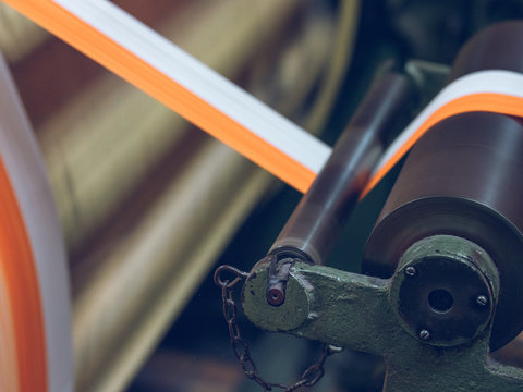 White and orange threads on loom