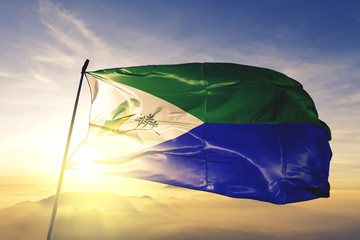 Rio Grande municipality of Puerto Rico flag waving on the top sunrise mist fog