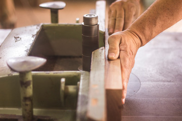 man pouring water into glass on a table