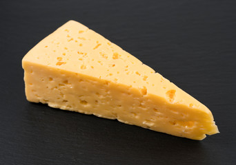 .piece of cheese on a black board