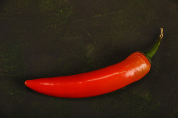 Red hot chilli pepper isolated on a brown background