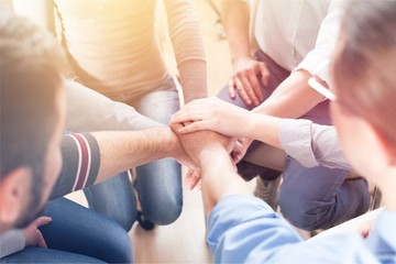 Close-up view of group of people stacking hands