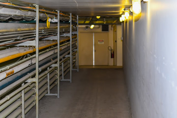Maintainance Hallway in an industrial building with conduit running down the side.