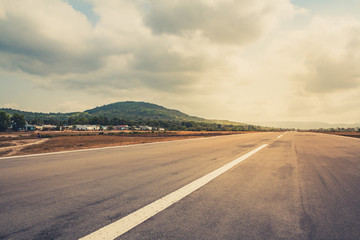 empty runway, straight highway road with dramatic sky  -