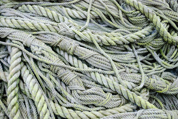 Fototapeta na wymiar Old rope piled up on a boat