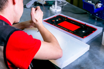 A worker extract the plastic detail from the mold. Manufacturing of plastic products. Medium business concept. Hands close-up